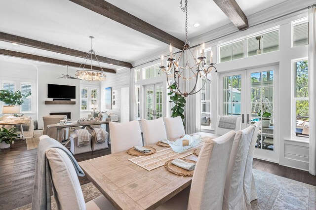 667 E Royal Fern Way, Santa Rosa Beach, FL 32459 - dining space featuring a chandelier, beam ceiling, dark wood finished floors, healthy amount of natural light, and a fireplace