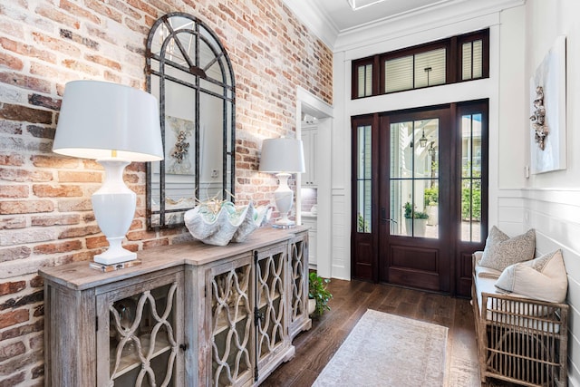 667 E Royal Fern Way, Santa Rosa Beach, FL 32459 - entryway featuring brick wall, ornamental molding, and dark wood-type flooring
