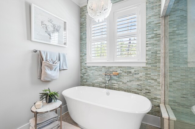 667 E Royal Fern Way, Santa Rosa Beach, FL 32459 - bathroom with a freestanding bath, a chandelier, and tile walls