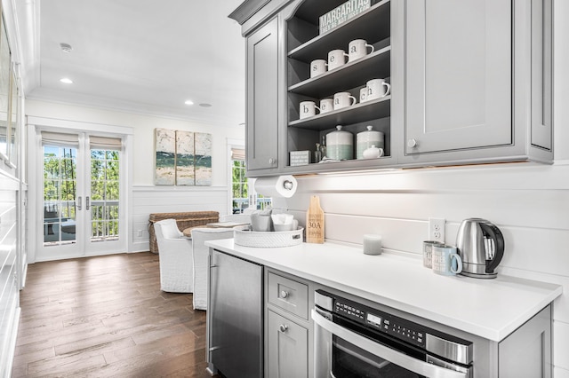 667 E Royal Fern Way, Santa Rosa Beach, FL 32459 - kitchen with stainless steel appliances, gray cabinets, open shelves, dark wood finished floors, and ornamental molding