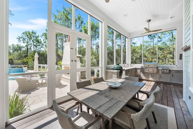 667 E Royal Fern Way, Santa Rosa Beach, FL 32459 - sunroom with an outdoor kitchen, a ceiling fan, and outdoor dining area