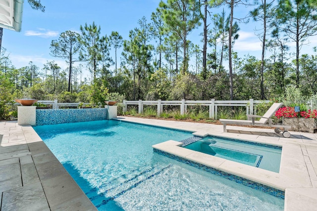667 E Royal Fern Way, Santa Rosa Beach, FL 32459 - view of pool featuring a patio area, a pool with connected hot tub, and view of wooded area
