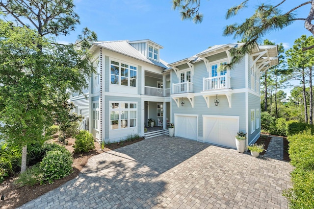 667 E Royal Fern Way, Santa Rosa Beach, FL 32459 - view of front of property featuring a balcony, decorative driveway, and an attached garage