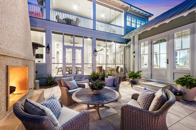 667 E Royal Fern Way, Santa Rosa Beach, FL 32459 - view of patio featuring french doors, a balcony, and an outdoor living space with a fireplace