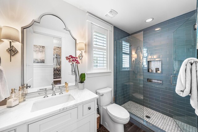 667 E Royal Fern Way, Santa Rosa Beach, FL 32459 - bathroom featuring vanity, toilet, a stall shower, wood finished floors, and recessed lighting