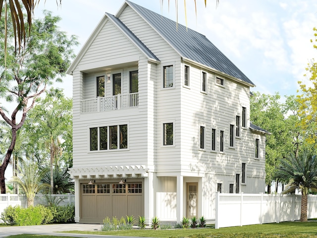 55 Grande Pointe Dr, Inlet Beach, FL 32461 - view of front of house with driveway, a balcony, an attached garage, and metal roof