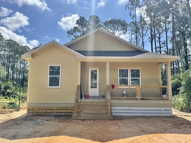 298 S 2nd St, Santa Rosa Beach, FL 32459 - bungalow-style house with covered porch and a shingled roof