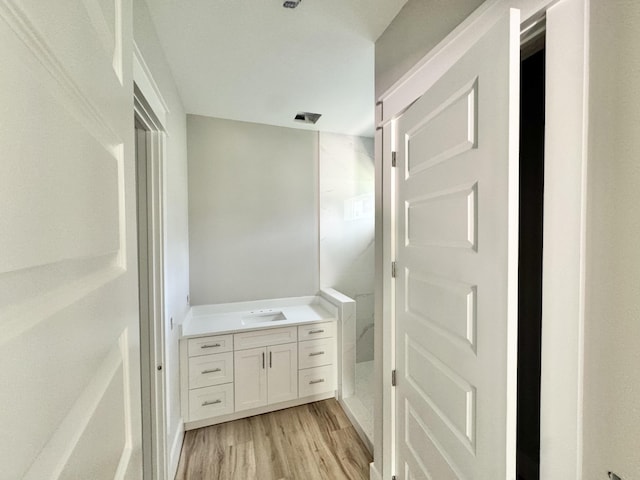 298 S 2nd St, Santa Rosa Beach, FL 32459 - bathroom featuring a stall shower, vanity, and wood finished floors