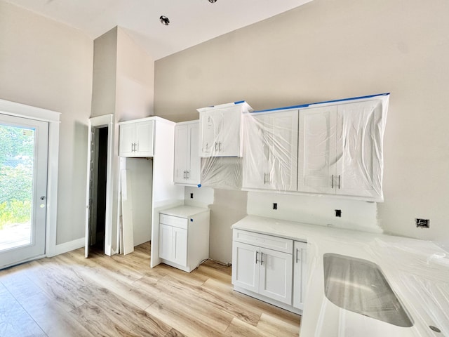 298 S 2nd St, Santa Rosa Beach, FL 32459 - washroom featuring light wood-style floors and a high ceiling