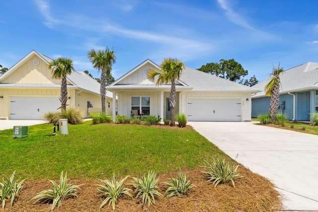 718 Backwater Rd, Port St Joe, FL 32456 - ranch-style home featuring board and batten siding, an attached garage, concrete driveway, and a front lawn