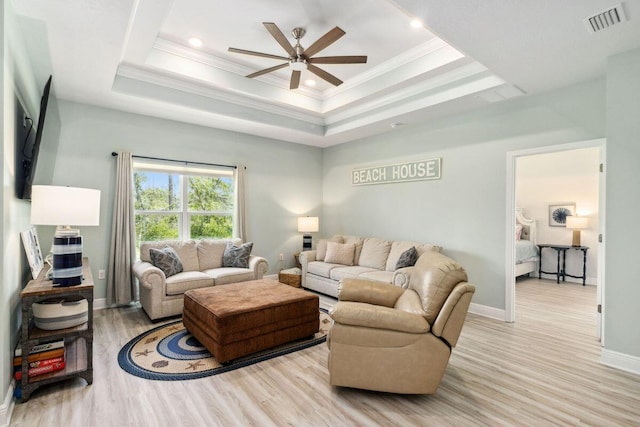 718 Backwater Rd, Port St Joe, FL 32456 - living area featuring ceiling fan, light wood-style flooring, crown molding, a tray ceiling, and baseboards