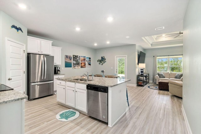 718 Backwater Rd, Port St Joe, FL 32456 - kitchen featuring stainless steel appliances, a sink, light wood-style floors, white cabinets, and recessed lighting
