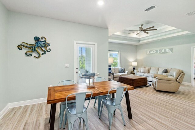 718 Backwater Rd, Port St Joe, FL 32456 - dining room with a ceiling fan, light wood-style floors, baseboards, a raised ceiling, and recessed lighting