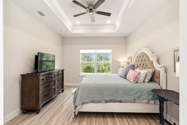 718 Backwater Rd, Port St Joe, FL 32456 - bedroom with light wood-type flooring, a raised ceiling, crown molding, baseboards, and a ceiling fan