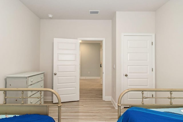 718 Backwater Rd, Port St Joe, FL 32456 - bedroom with light wood-type flooring and baseboards