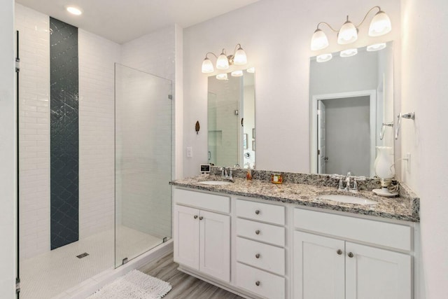 718 Backwater Rd, Port St Joe, FL 32456 - full bath featuring a tile shower, double vanity, wood finished floors, and recessed lighting