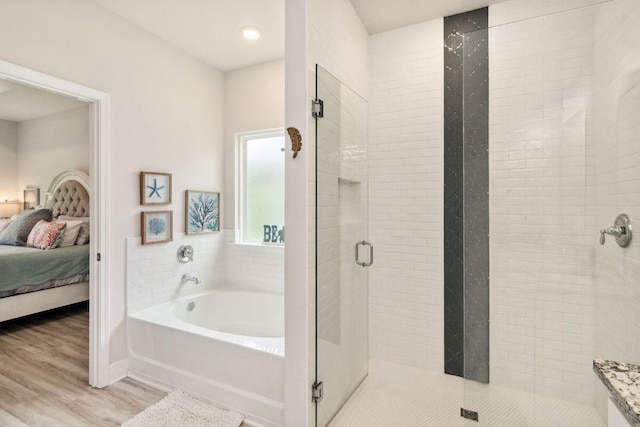 718 Backwater Rd, Port St Joe, FL 32456 - bathroom with a garden tub, a shower stall, connected bathroom, and wood finished floors