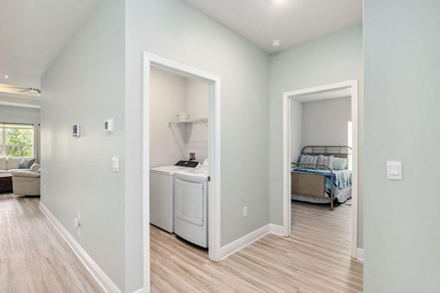 718 Backwater Rd, Port St Joe, FL 32456 - hallway featuring light wood-type flooring, independent washer and dryer, and baseboards
