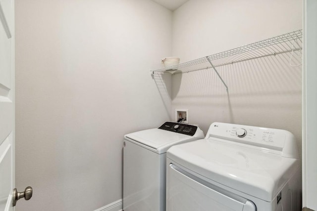 718 Backwater Rd, Port St Joe, FL 32456 - laundry area featuring washing machine and clothes dryer and baseboards