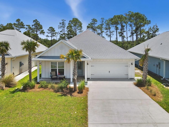 718 Backwater Rd, Port St Joe, FL 32456 - ranch-style house with board and batten siding, a garage, covered porch, driveway, and a front yard