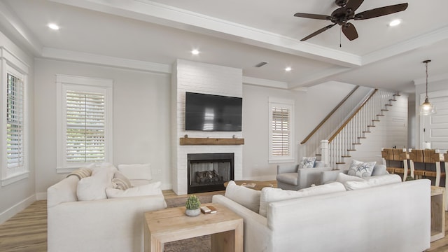 51 W Okeechobee, Santa Rosa Beach, FL 32459 - living room with a ceiling fan, stairway, a fireplace, ornamental molding, and light wood finished floors