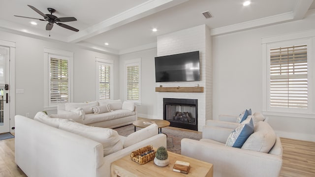 51 W Okeechobee, Santa Rosa Beach, FL 32459 - living room with light wood-style flooring, a ceiling fan, crown molding, recessed lighting, and a fireplace