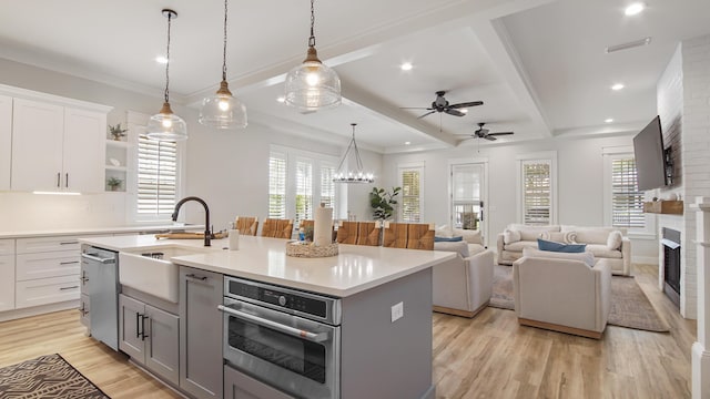 51 W Okeechobee, Santa Rosa Beach, FL 32459 - kitchen featuring a sink, stainless steel appliances, a fireplace, gray cabinets, and recessed lighting