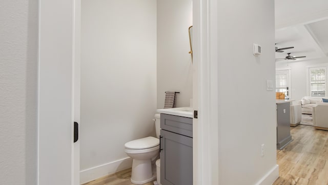 51 W Okeechobee, Santa Rosa Beach, FL 32459 - bathroom with vanity, wood finished floors, toilet, a ceiling fan, and baseboards