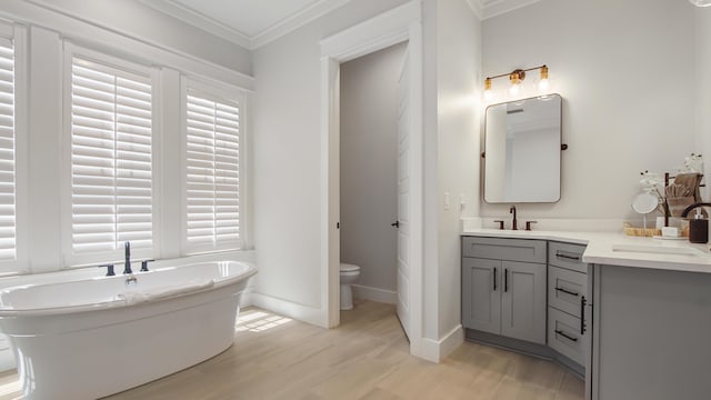 51 W Okeechobee, Santa Rosa Beach, FL 32459 - full bath featuring vanity, crown molding, a freestanding tub, wood finished floors, and toilet