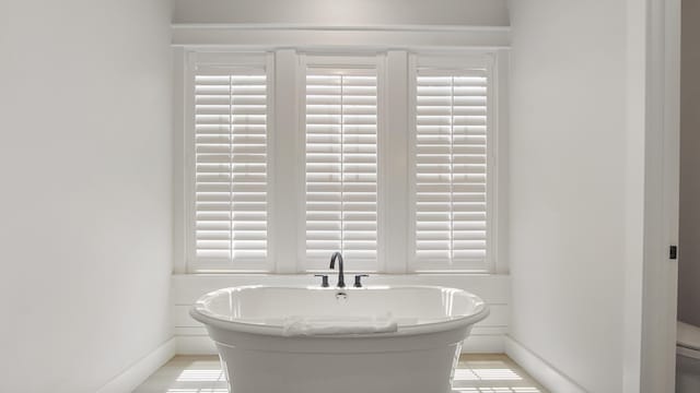 51 W Okeechobee, Santa Rosa Beach, FL 32459 - bathroom featuring a freestanding tub and baseboards