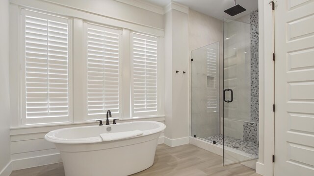 51 W Okeechobee, Santa Rosa Beach, FL 32459 - bathroom with a stall shower, wood finished floors, a soaking tub, and baseboards