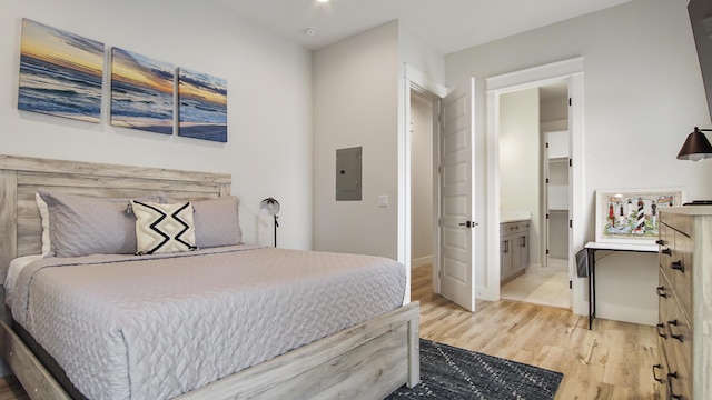 51 W Okeechobee, Santa Rosa Beach, FL 32459 - bedroom featuring electric panel, light wood-type flooring, ensuite bathroom, and baseboards
