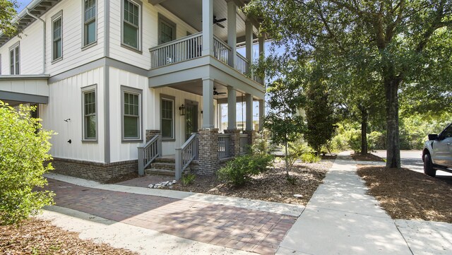51 W Okeechobee, Santa Rosa Beach, FL 32459 - entrance to property with a ceiling fan, a balcony, and board and batten siding