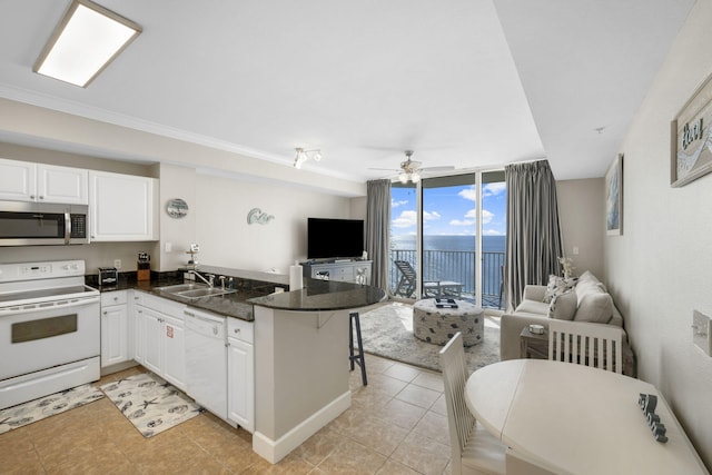 16819 Front Beach Rd Unit 2116, Panama City Beach, FL 32413 - kitchen with white appliances, open floor plan, a sink, a peninsula, and a wall of windows