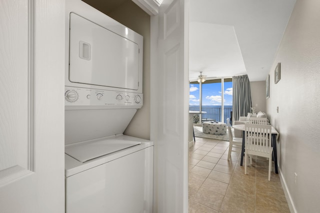 16819 Front Beach Rd Unit 2116, Panama City Beach, FL 32413 - washroom featuring stacked washing machine and dryer and light tile patterned floors