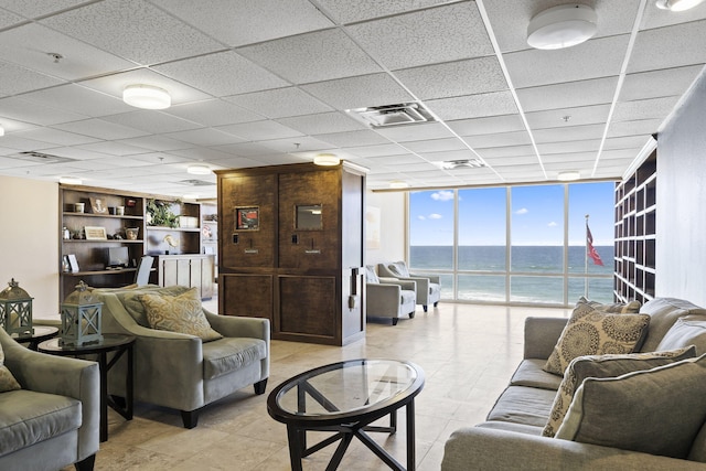 16819 Front Beach Rd Unit 2116, Panama City Beach, FL 32413 - living room featuring a water view, a paneled ceiling, a wall of windows, and built in shelves