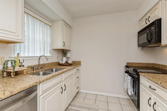 104 Country Club Dr Unit 104, Niceville, FL 32578 - kitchen featuring black appliances, a sink, light tile patterned flooring, baseboards, and light stone counters