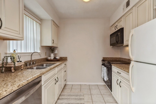 104 Country Club Dr Unit 104, Niceville, FL 32578 - kitchen featuring black appliances, a sink, light tile patterned floors, baseboards, and light stone counters