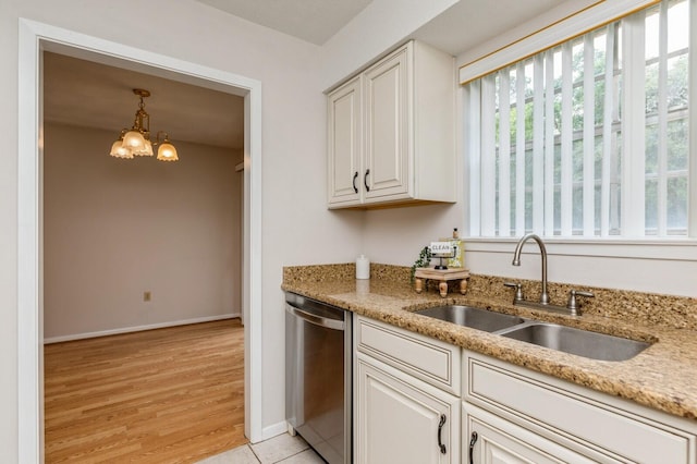 104 Country Club Dr Unit 104, Niceville, FL 32578 - kitchen with dishwasher, a sink, light stone countertops, light wood finished floors, and a chandelier