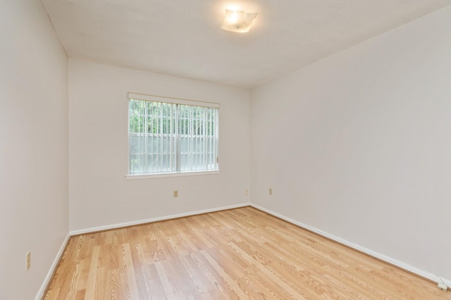 104 Country Club Dr Unit 104, Niceville, FL 32578 - spare room featuring wood finished floors and baseboards