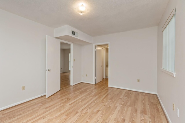 104 Country Club Dr Unit 104, Niceville, FL 32578 - spare room featuring light wood-style floors, baseboards, and a textured ceiling