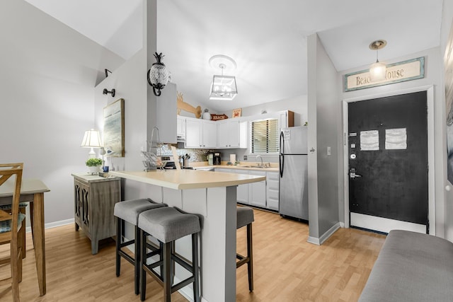 3755 Scenic Highway 98 Unit 1203, Destin, FL 32541 - kitchen featuring stainless steel appliances, a sink, a peninsula, a kitchen breakfast bar, and light countertops