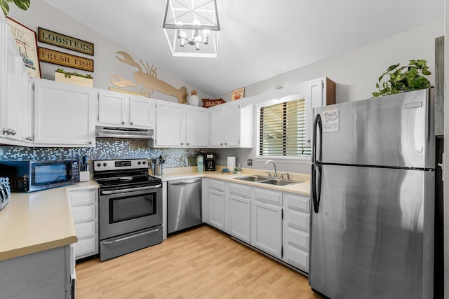 3755 Scenic Highway 98 Unit 1203, Destin, FL 32541 - kitchen with appliances with stainless steel finishes, under cabinet range hood, a sink, lofted ceiling, and light countertops