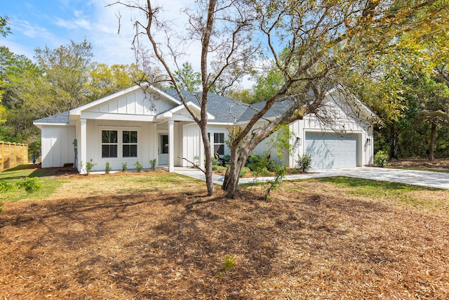 335 J Hunters Way S, Freeport, FL 32439 - view of front of property featuring concrete driveway, a garage, board and batten siding, and a shingled roof
