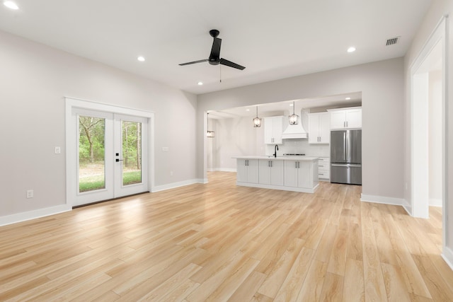 335 J Hunters Way S, Freeport, FL 32439 - unfurnished living room with a ceiling fan, light wood finished floors, recessed lighting, baseboards, and french doors