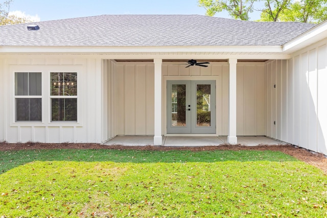335 J Hunters Way S, Freeport, FL 32439 - view of exterior entry featuring a shingled roof, ceiling fan, a yard, board and batten siding, and french doors