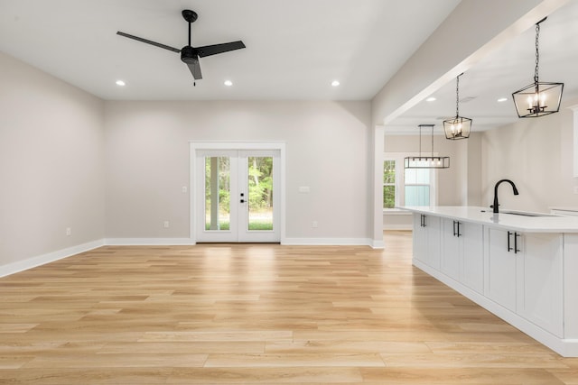 335 J Hunters Way S, Freeport, FL 32439 - unfurnished living room with a sink, recessed lighting, a ceiling fan, light wood finished floors, and baseboards