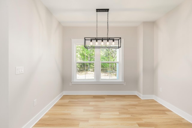 335 J Hunters Way S, Freeport, FL 32439 - unfurnished dining area with light wood-style floors and baseboards