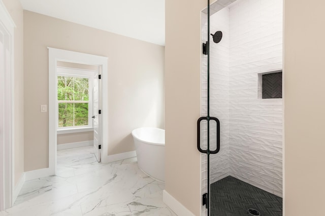 335 J Hunters Way S, Freeport, FL 32439 - bathroom featuring baseboards, a stall shower, marble finish flooring, and a soaking tub