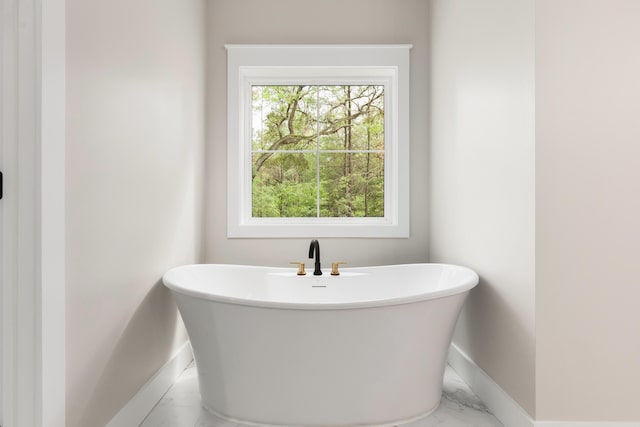 335 J Hunters Way S, Freeport, FL 32439 - full bath featuring baseboards, a freestanding tub, and marble finish flooring